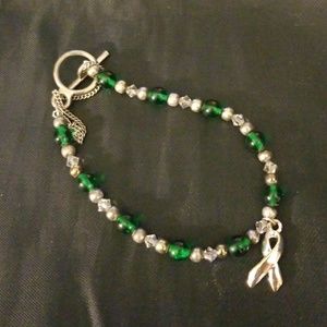 Green, silver and clear beaded bracelet w/ ribbon